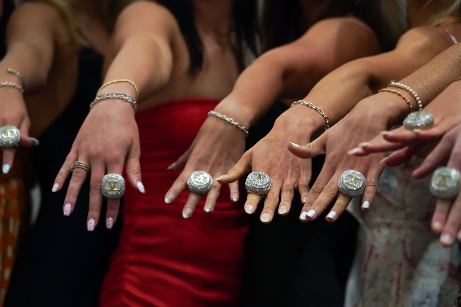 Championship rings on the hands of Virginia swimmers